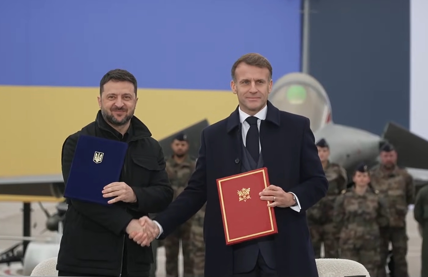 Macron and Zelensky Sign Agreement to Strengthen Ukraine’s Defense, With Rafale Jet in Background