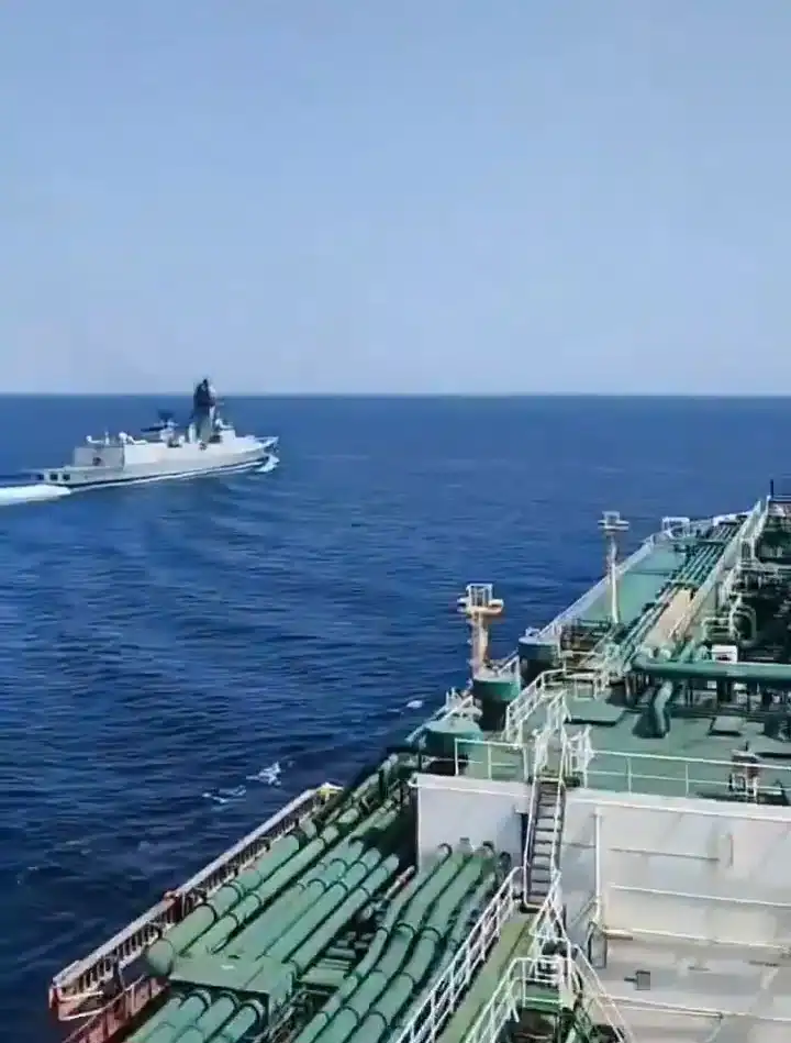 An Indian Navy ship escorts a tanker through the Gulf of Oman. Photo credits: Naval News