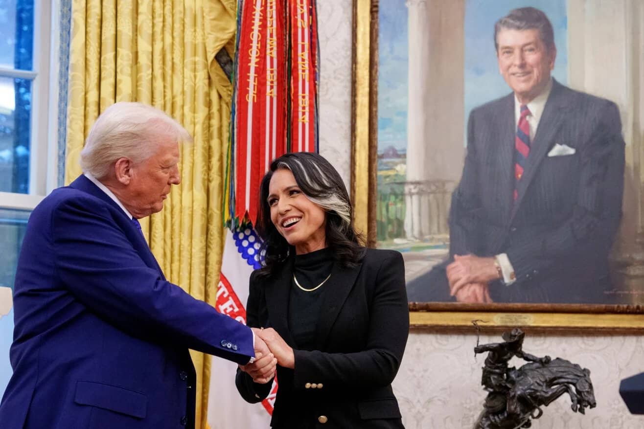 Tulsi Gabbard shakes hands with US President Donald Trump in the Oval Office on February 12, 2026. Source: Getty Images